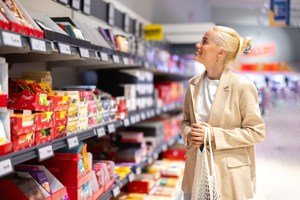 Shopper browsing supermarket shelves